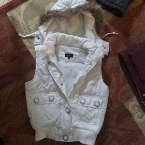 White vest with furry hood buttons and zips up